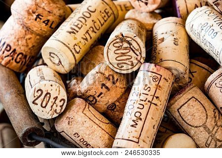 Old Cork Stoppers Of French Wines In A Wire Basket