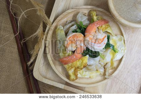 Fry Noodle With Shrimp And Egg Soak In Gravy On Wood Dish, Thai Style Food