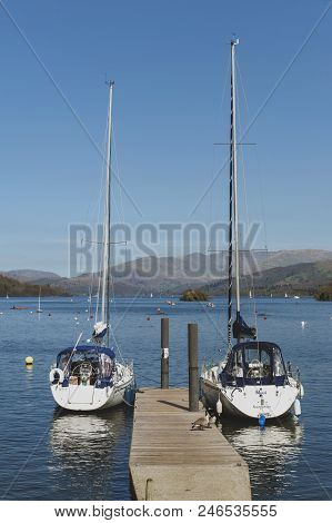 South Lakeland, Uk - April 2018: Bowness Pier With Boats For Hire And Tourist Cruises At Bowness-on-