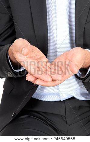 A Close Up Image Of The Middle Section Of A Business Man Holding His 
Hands Open To Receive Somethin