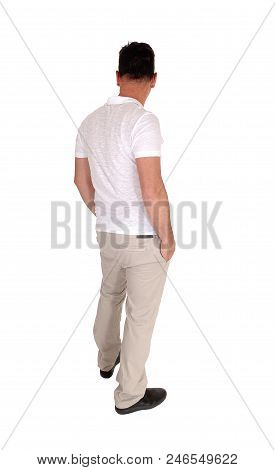A Tall Handsome Middle Age Man Standing In A Beige Slacks And White T-shirt 
With His Hands In His P