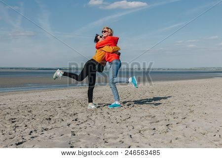 Happy Friends Hugging On Sandy Beach, Saint Michaels Mount, Normandy, France
