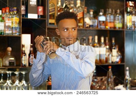 Professional Bartender Man Holding In Hands A Shaker With A Fresh Delicious Cocktail. Bartender Shak