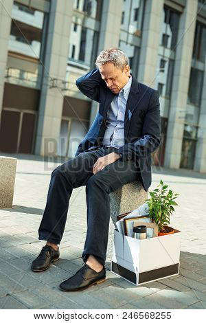 Personnel Redundancy. Elderly Wrinkled Man Feeling Unbelievably Sad After Personnel Redundancy At Hi