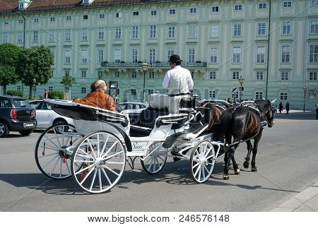 Vienna, Austria - July 13, 2018: Close Up Of Tourists In A Horse-drawn Carriage Called Fiaker At The