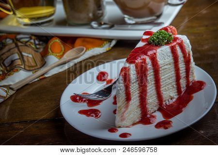 Strawberry Crape Cake On Wood Table In Coffee Shop , Dessert Tasy Cake