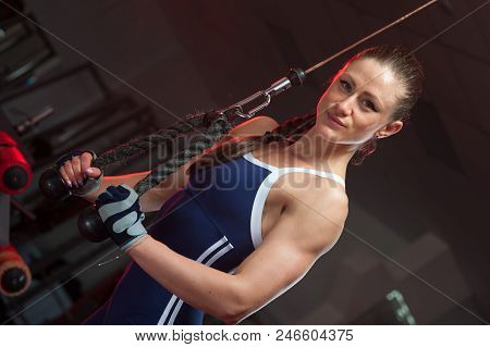 Slim Pretty Woman In Sportswear Posing On Simulator Machine In The Gym. Sports And Fitness Concept.