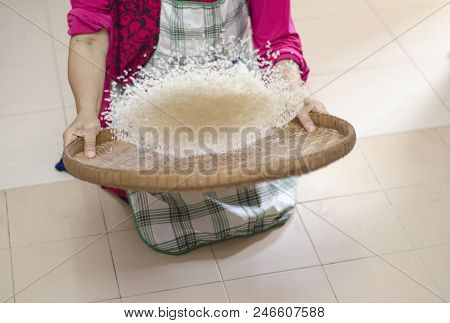Housewife Winnowing Rice By Using Bamboo Basketwork For Separate Between Rice And Rice Husk.selectiv