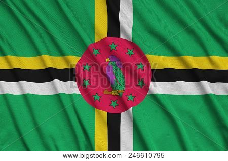 Dominica Flag  Is Depicted On A Sports Cloth Fabric With Many Folds. Sport Team Waving Banner