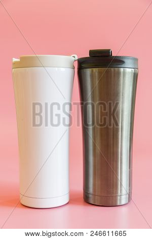 Two Insulated Cups On A Pink Background. Thermo Cup, Thermo Glasses. The Concept Of A Hike And Free 