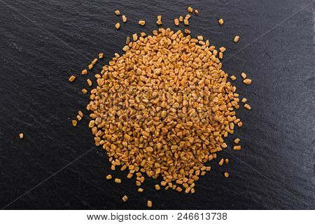 Fragrant Grains Of Fenugreek On A Rustic Background.