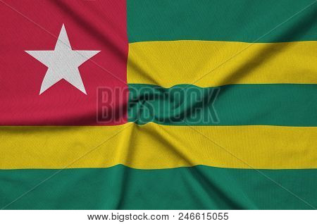 Togo Flag  Is Depicted On A Sports Cloth Fabric With Many Folds. Sport Team Waving Banner