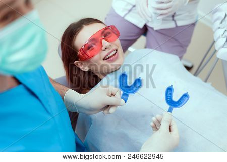 Doctor Orthodontist Performs A Procedure For Cleaning Teeth