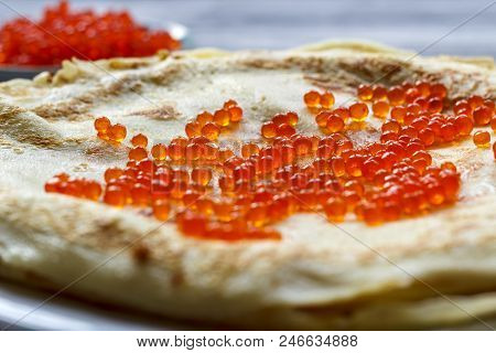 Pancakes With Red Caviar In A White Plate On A Wooden Background. Celebration Of Maslenitsa