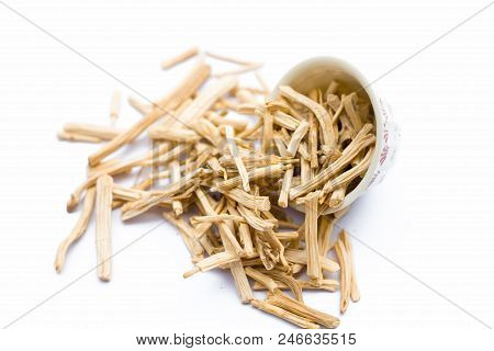 Close Up Of Ayurvedic Herb  Satavari Or Kurilo Or Asparagus Racemosus Isolated On White In A Glass B