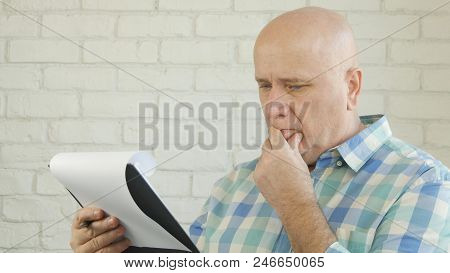 Preoccupied Businessman Image Reading Information Using Clipboard