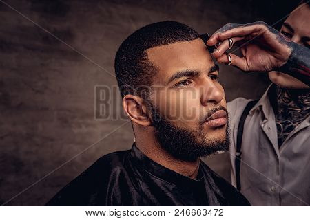 Bearded African American Hipster Guy Getting A Haircut By An Old-fashioned Tattoed Professional Hair