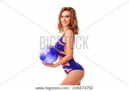 Pretty Bikini Model Holding Blue Ball In Studio On Red Background