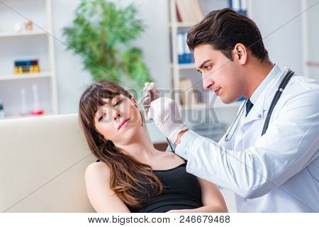 Doctor checking patients ear during medical examination