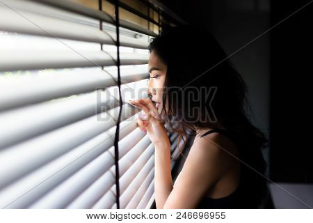 Attractive Beautiful Woman Look Through Window Outside House. Charming Beautiful Girl Is Waiting Her
