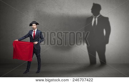 Businessman standing with red cloth on his hand and his shadow on the background