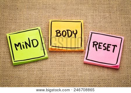 mind and body reset - handwriting on sticky notes against burlap canvas