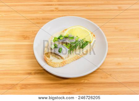 Open Sandwich Made Of White Bread, Butter, Slices Of Fillet Of Pickled Atlantic Herring, Lemon And G