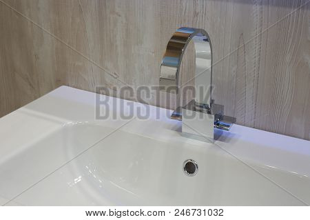 Moderm Metal Shiny Mixer Mounted On White Ceramic Washbasin