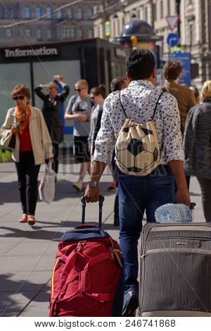 ST. PETERSBURG, RUSSIA - JUNE 20, 2018: Group of Indian football fans at Moskovsky train station of Saint Petersburg during FIFA World Cup Russia 2018. The city hosts 7 matches of FIFA World Cup