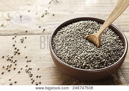 Cannabis Seeds In A Plate, On A Wooden Background, Space For Text