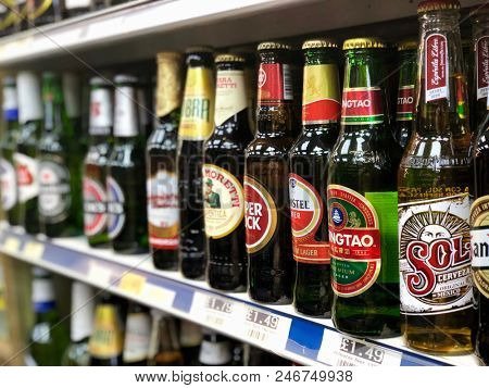 LONDON - 24 JUNE, 2018: A selection of premium lagers on sale on the shelf of an off license in London, UK.