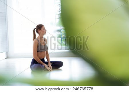 Photo Of A Young, Beautiful Woman, Doing Yoga And The Lotus Posity In The Studio, Beautiful And Heal
