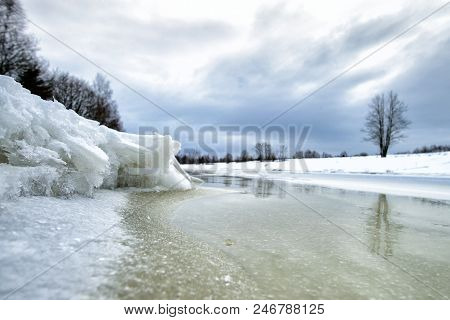 Close-up Of Rivulet On Cold Winter Day. Winter Landscape