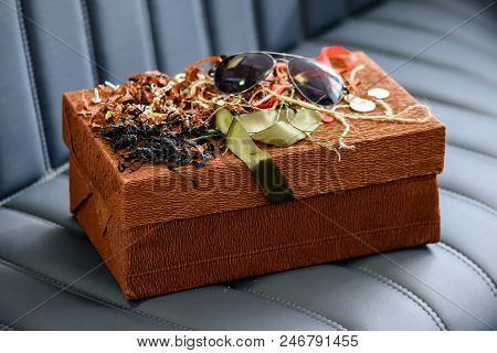 Holiday Decor Concept. Handmade Gift Box Wrapped With Simple Brown Paper And Decorated With Ribbon A