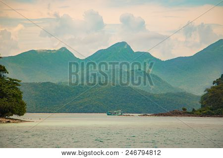 Island Sea View On Bright Blue Beach From Tropical. Clouds On Horizon And Some Storm Clouds. Outdoor