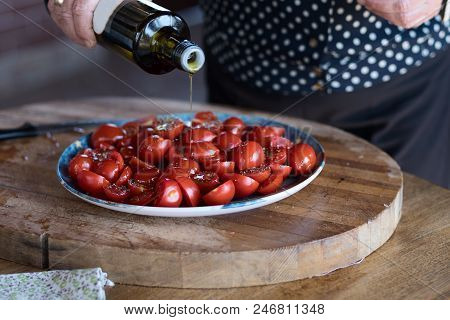 Fresh Cherry Tomatoes Under Oil And Seasoning On The Table, Summer Terrace. Concept Of Healthy Food,