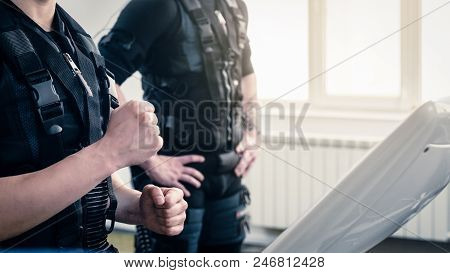 Athletic Woman Standing Near Ems Machine During Training