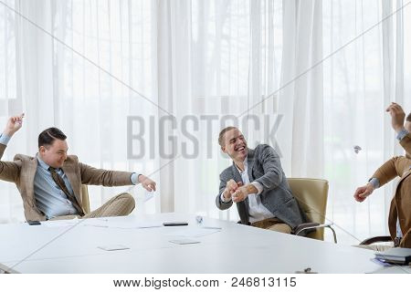 Business Men Throwing Papers And Having Fun At The Board Meeting. Small Break From Work To Relax. Ch