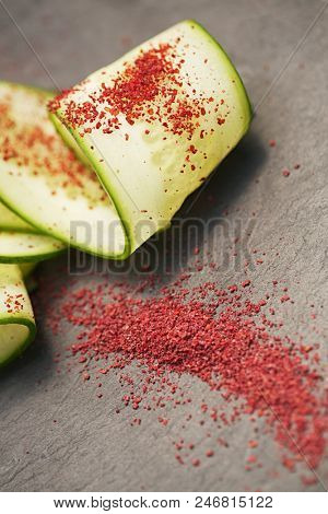 Ground Red Sumac Berries sprinkled on cucumber slice