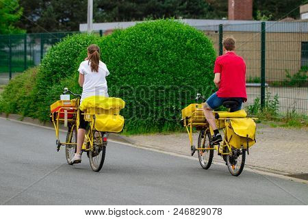 Postman Riding His Cargo Bike Carrying Out Mail In Neighborhood