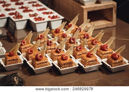 Cake Honey Cake On White Plates For Guests At The Wedding Catering.