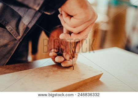 The Carpente Makes Hole With An Awl On A Furniture Details Toned Image. Makes A Mark For The Hole Wi