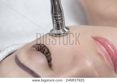 The Cosmetologist Makes The Procedure Microdermabrasion Of The Facial Skin Of A Beautiful, Young Wom