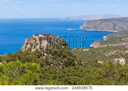 The Castle Of Monolithos Located At The Summit Of The Tall And Craggy Rock. Rhodes Island, Greece