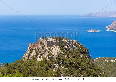 The Castle Of Monolithos Located At The Summit Of The Tall And Craggy Rock. Rhodes Island, Greece