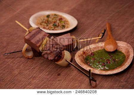 Grilled Pork Meat With Sauce Inserted With Bamboo Sticks. Shallow Dof.
