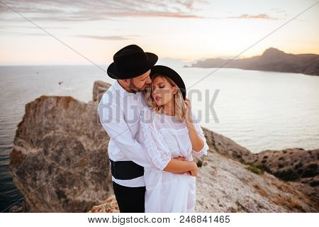 Romantic Summer Love Story On A Sunset In Mountains. Young Girl And Boy In Love.