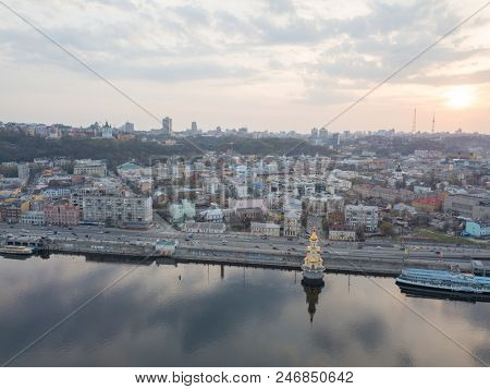 Kiev, Ukraine: 15 April, 2018 - Church of St. Nicholas the Wonderworker on Dnieper River on sunset, photography from drone