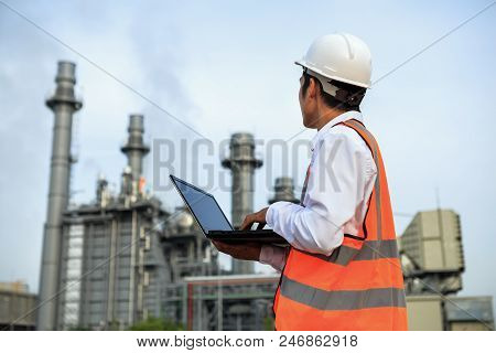 Engineer In Uniform And Helmet On Of Background The Construction Site Power Plant.