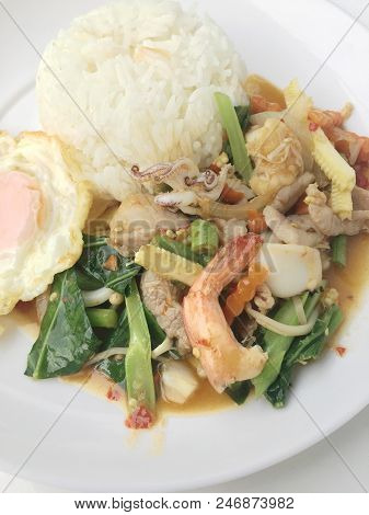 Vegetable Stir-fry Dishes With Spicy  Seafood With Basil Leaves And Mixed Vegetable And Fried Egg On